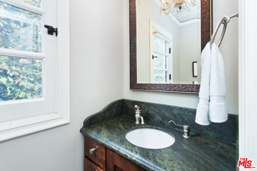 3937 Roderick Road Los Angeles, CA 90065 - Photo 14 of 28 a bathroom with a granite countertop sink and a mirror