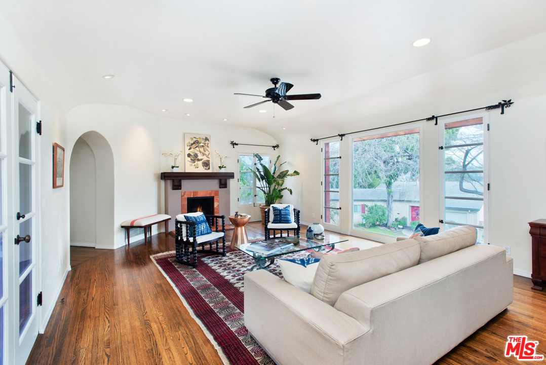3937 Roderick Road Los Angeles, CA 90065 - Photo 5 of 28 a living room with furniture a fireplace and a chandelier