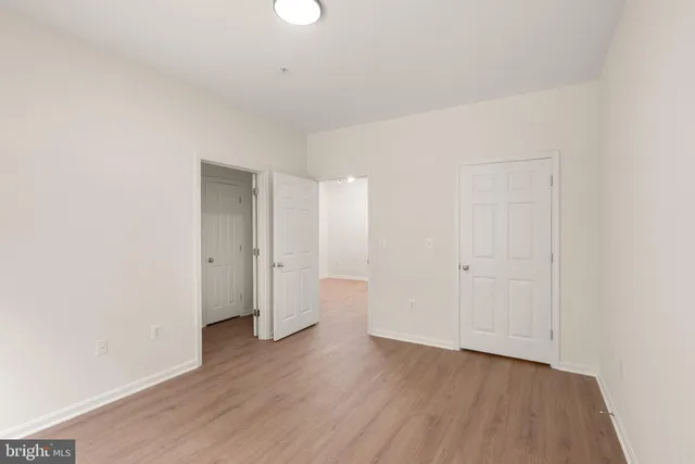 a bathroom with a granite countertop sink a toilet and a large mirror