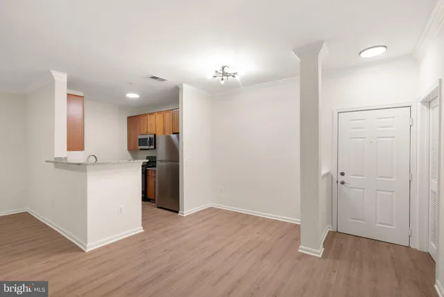 a kitchen with stainless steel appliances granite countertop a refrigerator a stove a sink dishwasher and a microwave