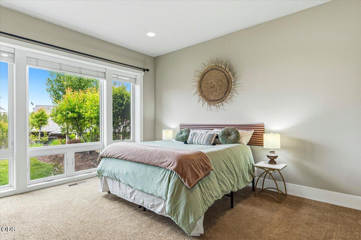 61333 Kindle Rock Loop Bend, OR 97702 - Photo 32 of 53 a bedroom with a bed and window