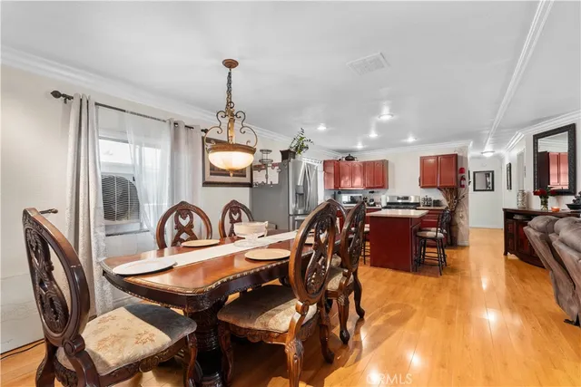 a bedroom with a bed wooden floor and window
