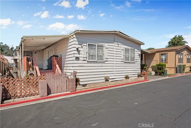an aerial view of a house with a yard and sitting space