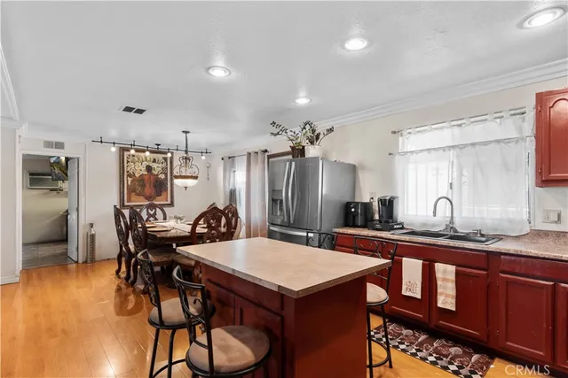 a kitchen with a table chairs refrigerator and cabinets