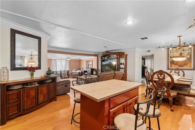 a view of a a dining room with furniture window and wooden floor