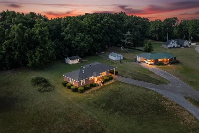 an aerial view of a house with a yard