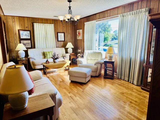 a living room with furniture and a chandelier