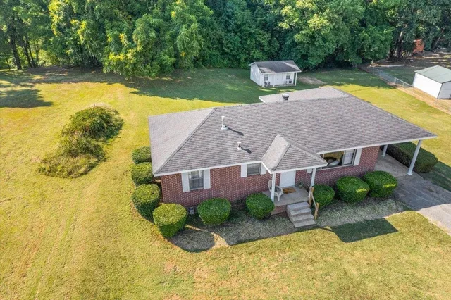 a aerial view of a house with swimming pool and sitting area