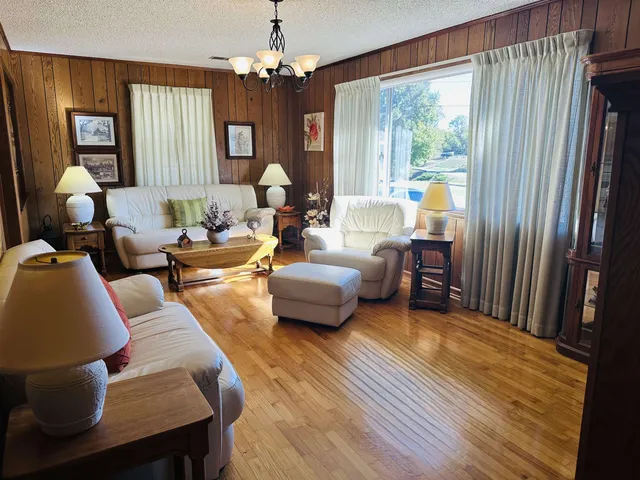 a living room with furniture and a chandelier