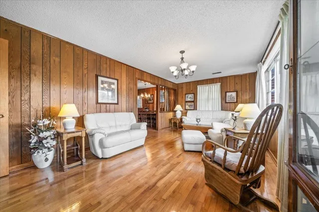 a living room with furniture and a chandelier