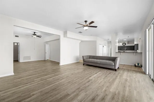 a view of a livingroom with furniture and a kitchen