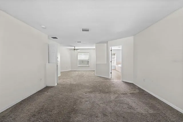 an empty room with windows and pillars in it