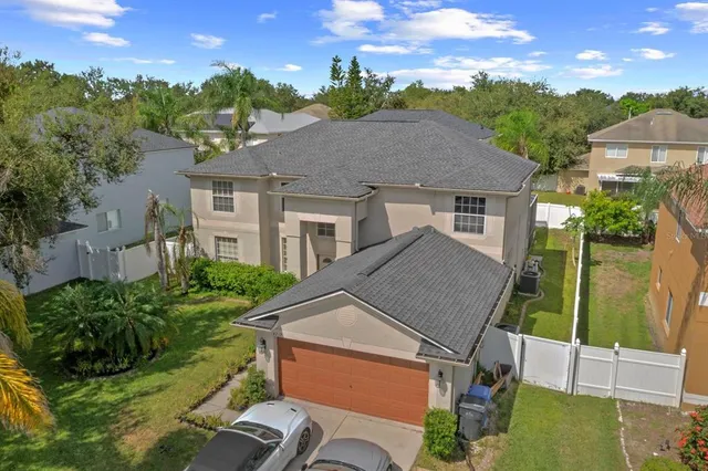 a aerial view of a house next to a yard