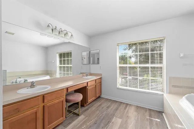 a spacious bathroom with a granite countertop sink and a large mirror