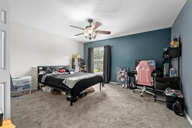a bedroom with bed and a chandelier