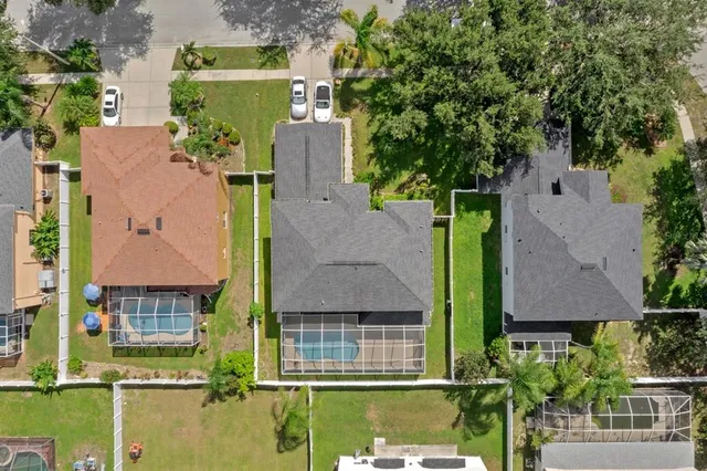 an aerial view of a house with a yard basket ball court and outdoor seating