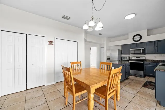 a view of a dining room with furniture and a chandelier