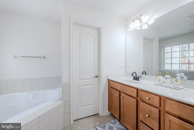 a bathroom with a granite countertop tub toilet and a shower