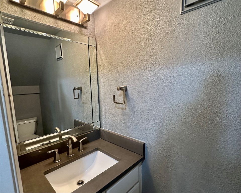 2018 West Rundberg Lane, Unit 5B Austin, TX 78758 - Photo 11 of 23 a bathroom with a sink a mirror and shower