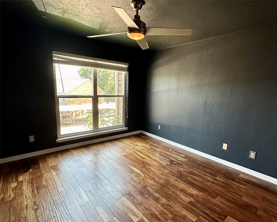 2018 West Rundberg Lane, Unit 5B Austin, TX 78758 - Photo 13 of 23 a view of empty room with wooden floor and fan
