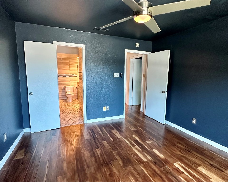 2018 West Rundberg Lane, Unit 5B Austin, TX 78758 - Photo 14 of 23 a view of an empty room with wooden floor and a window