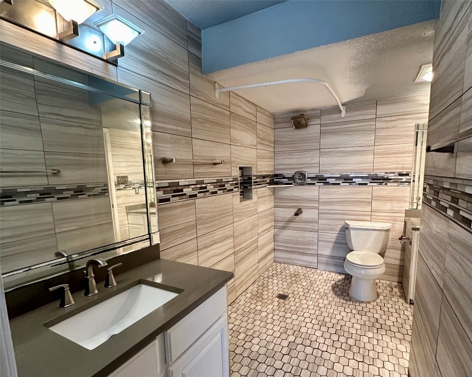 2018 West Rundberg Lane, Unit 5B Austin, TX 78758 - Photo 16 of 23 a bathroom with a sink a toilet and shower