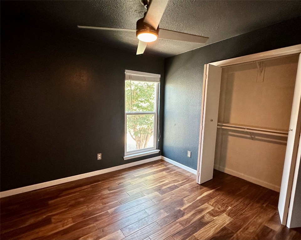 2018 West Rundberg Lane, Unit 5B Austin, TX 78758 - Photo 19 of 23 a view of empty room with wooden floor and fan