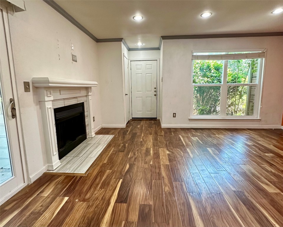 2018 West Rundberg Lane, Unit 5B Austin, TX 78758 - Photo 6 of 23 a view of a livingroom with wooden floor and a fireplace
