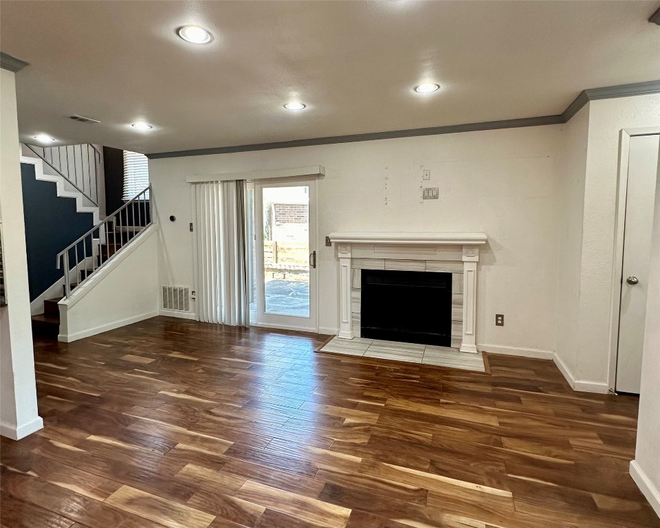 2018 West Rundberg Lane, Unit 5B Austin, TX 78758 - Photo 7 of 23 a view of an empty room with wooden floor fireplace and a window