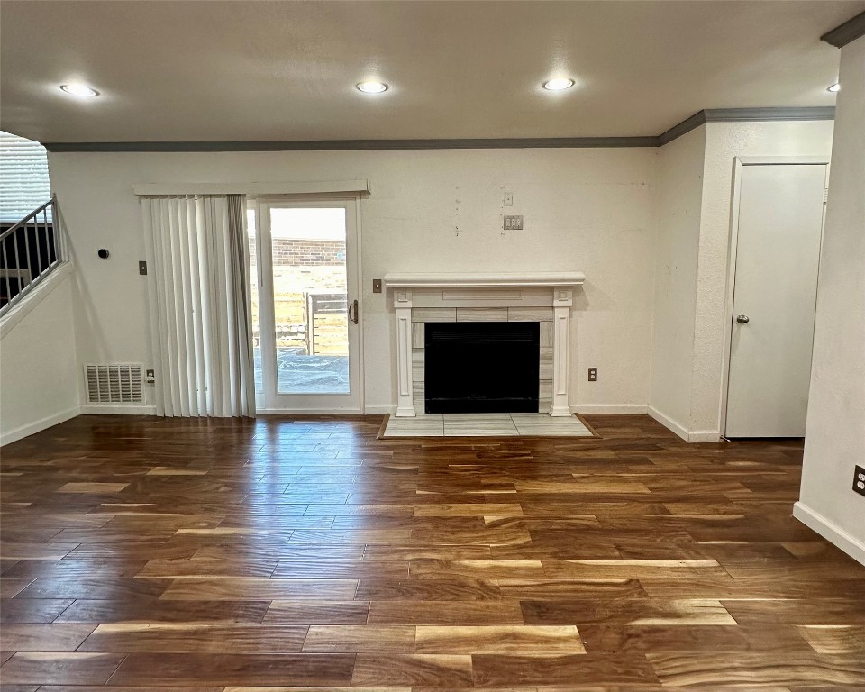 2018 West Rundberg Lane, Unit 5B Austin, TX 78758 - Photo 8 of 23 a view of an empty room with wooden floor and a fireplace