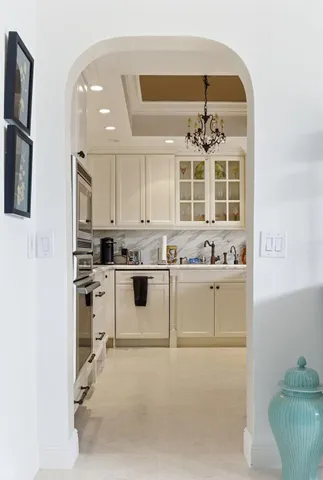 a kitchen with granite countertop white cabinets and white appliances