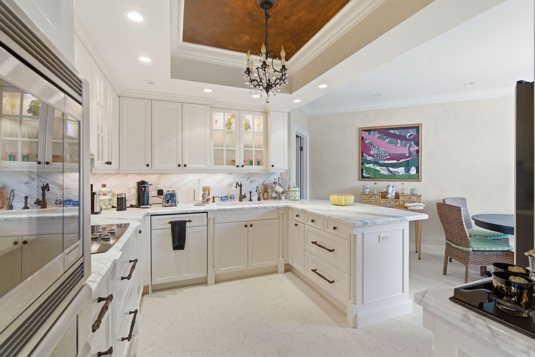 2500 South Ocean Boulevard, Unit 1A1 Palm Beach, FL 33480 - Photo 12 of 34 a large white kitchen with cabinets