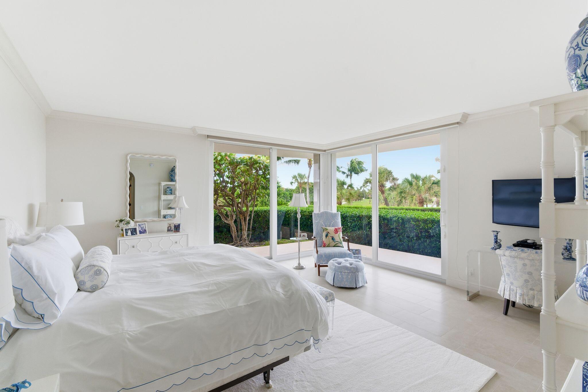 2500 South Ocean Boulevard, Unit 1A1 Palm Beach, FL 33480 - Photo 15 of 34 a bedroom with a bed and large windows