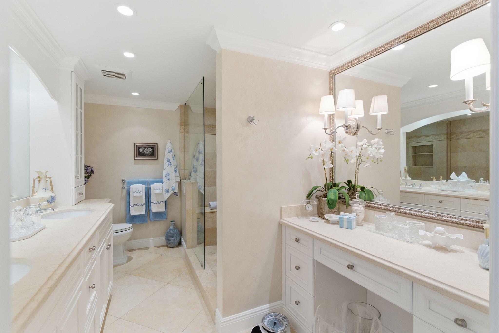 2500 South Ocean Boulevard, Unit 1A1 Palm Beach, FL 33480 - Photo 18 of 34 a spacious bathroom with a granite countertop sink a mirror and a toilet