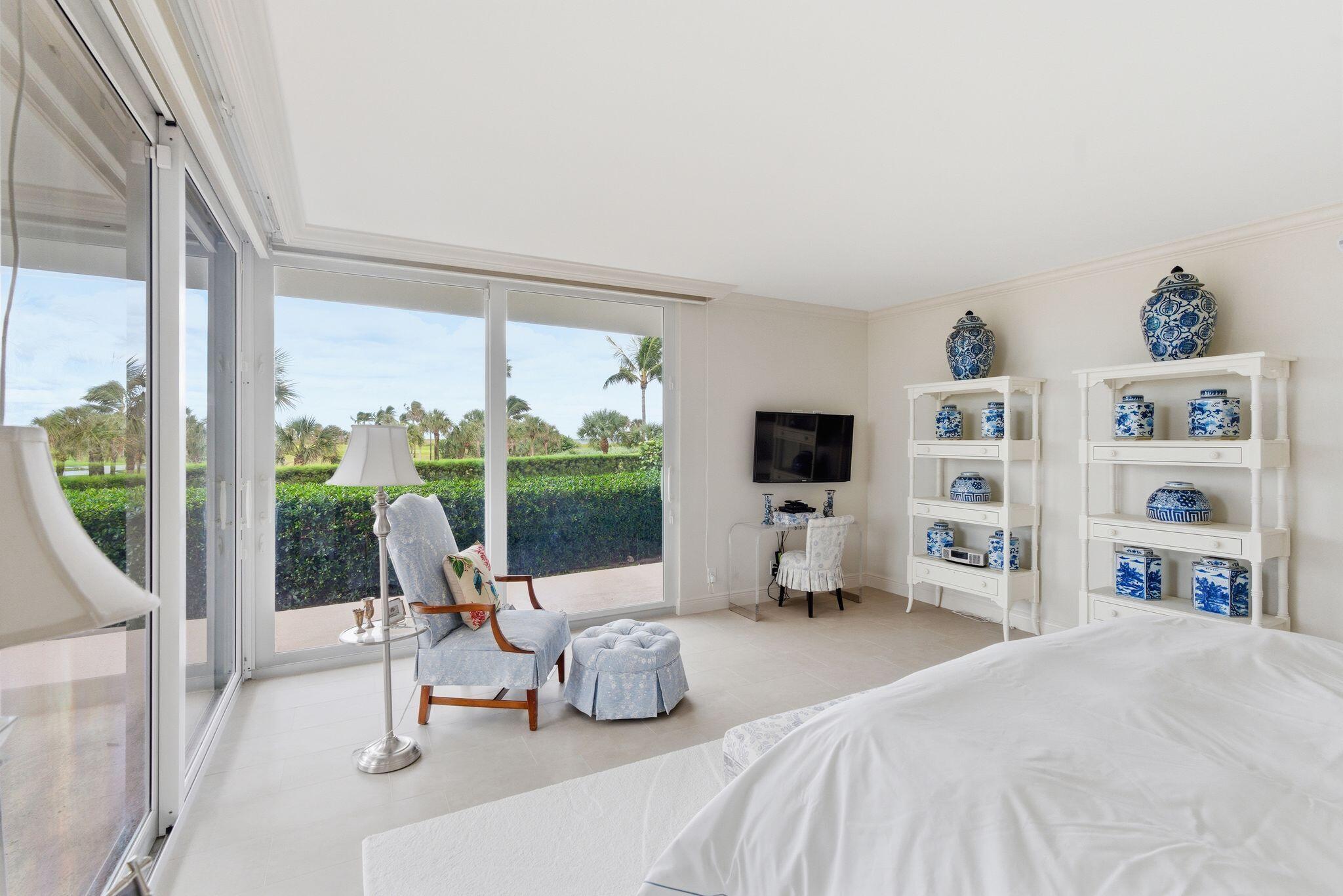 2500 South Ocean Boulevard, Unit 1A1 Palm Beach, FL 33480 - Photo 20 of 34 a bedroom with a bed a large window and book shelf