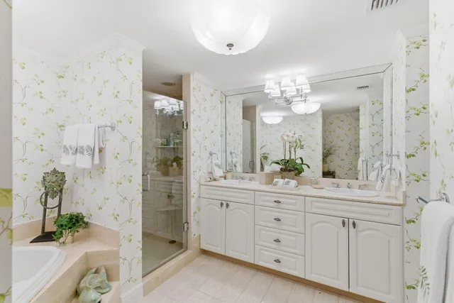 a spacious bathroom with a granite countertop sink a large mirror a shower and a mirror
