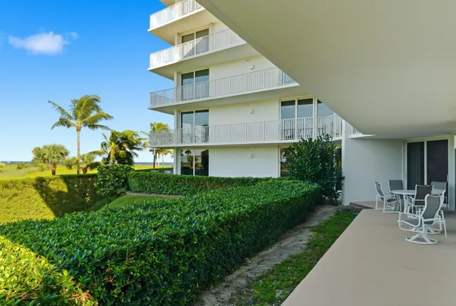 a front view of a house with a yard and fountain