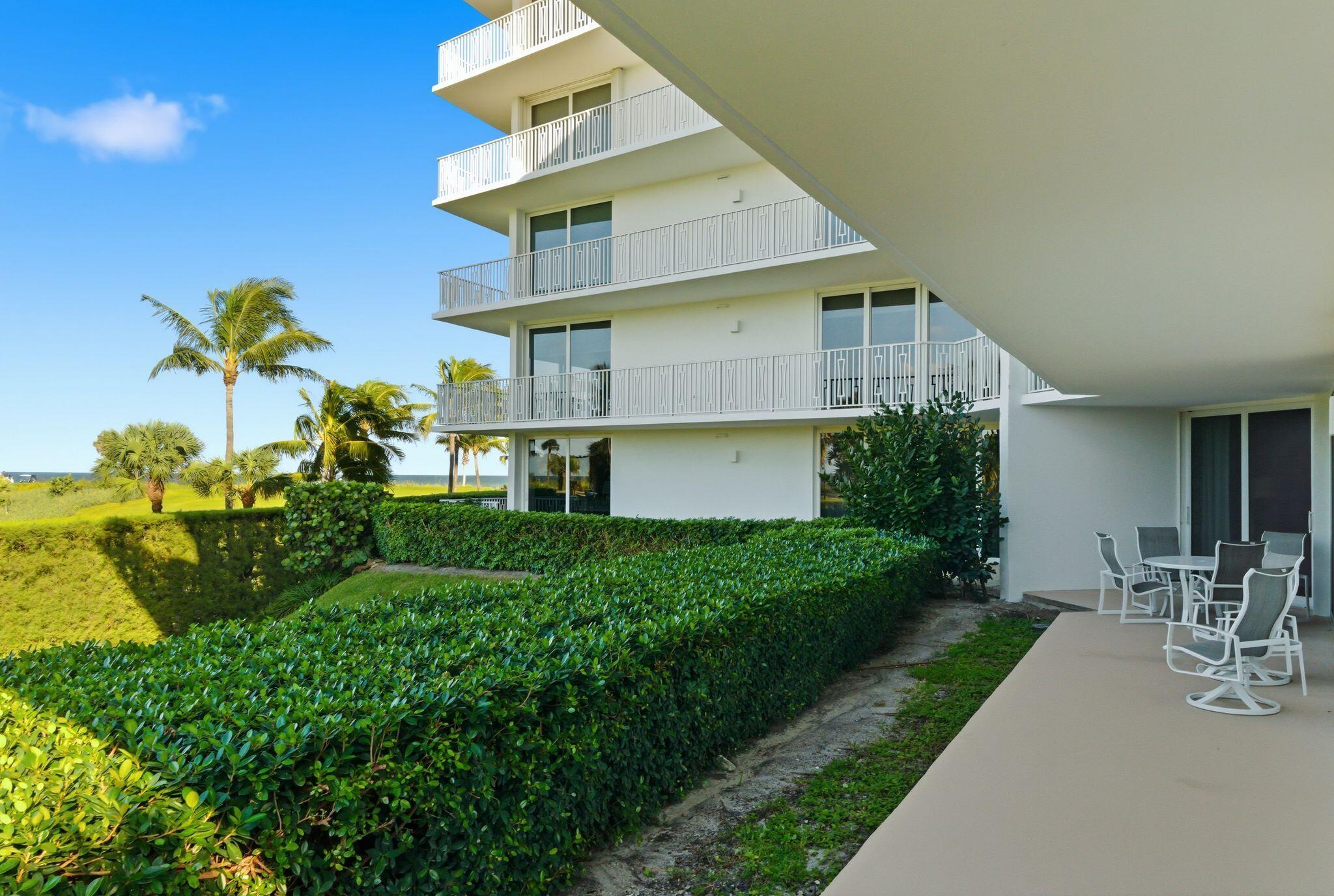 2500 South Ocean Boulevard, Unit 1A1 Palm Beach, FL 33480 - Photo 27 of 34 a front view of a house with a yard and fountain