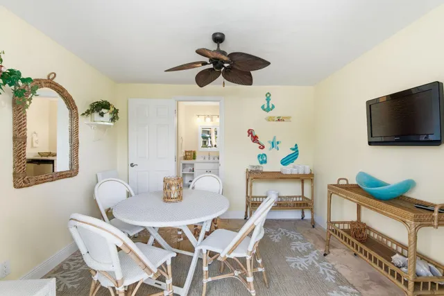 a view of a dining room with furniture and a flat screen tv