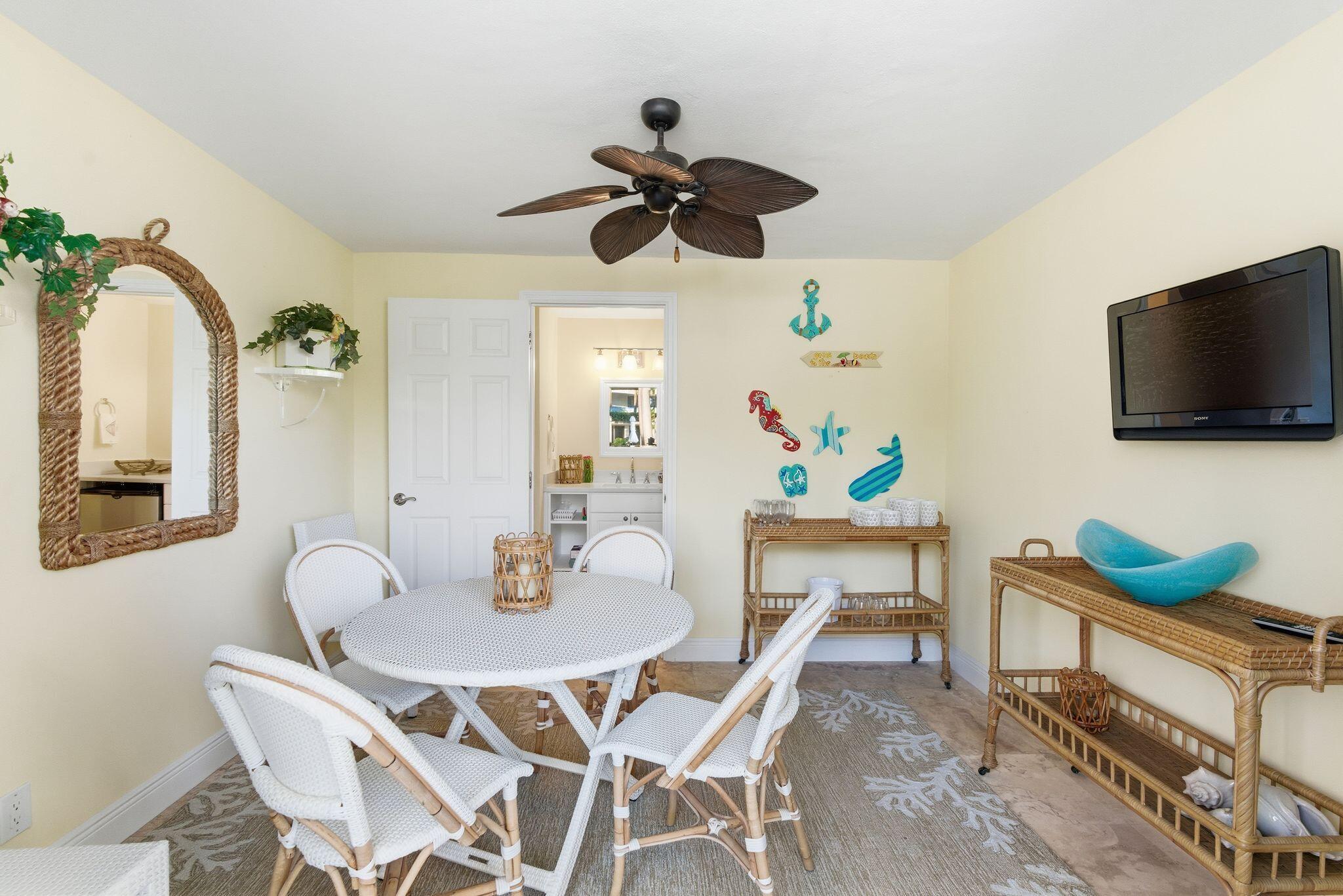 2500 South Ocean Boulevard, Unit 1A1 Palm Beach, FL 33480 - Photo 31 of 34 a view of a dining room with furniture and a flat screen tv