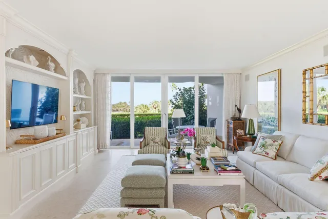 a living room with furniture and large windows