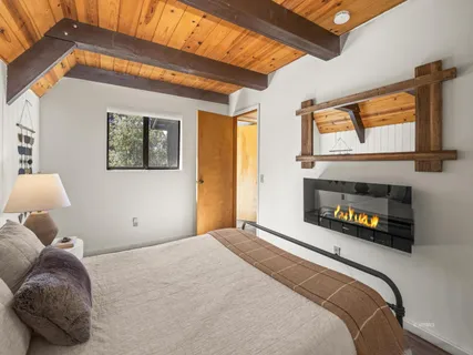 a bedroom with a bed and a large window