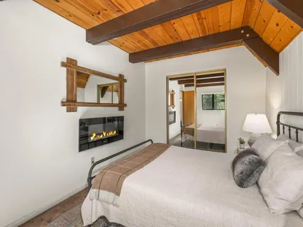 a bedroom with a bed and a fireplace