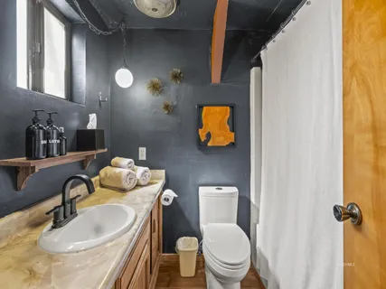 a bathroom with a toilet sink and mirror
