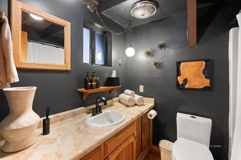 a bathroom with a toilet sink and mirror