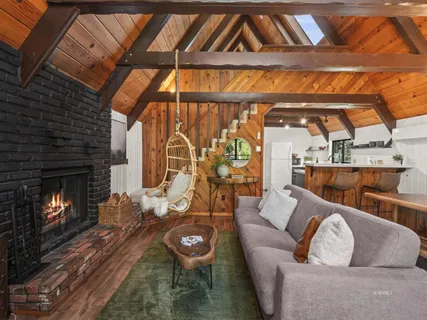a living room with furniture a fireplace and a window