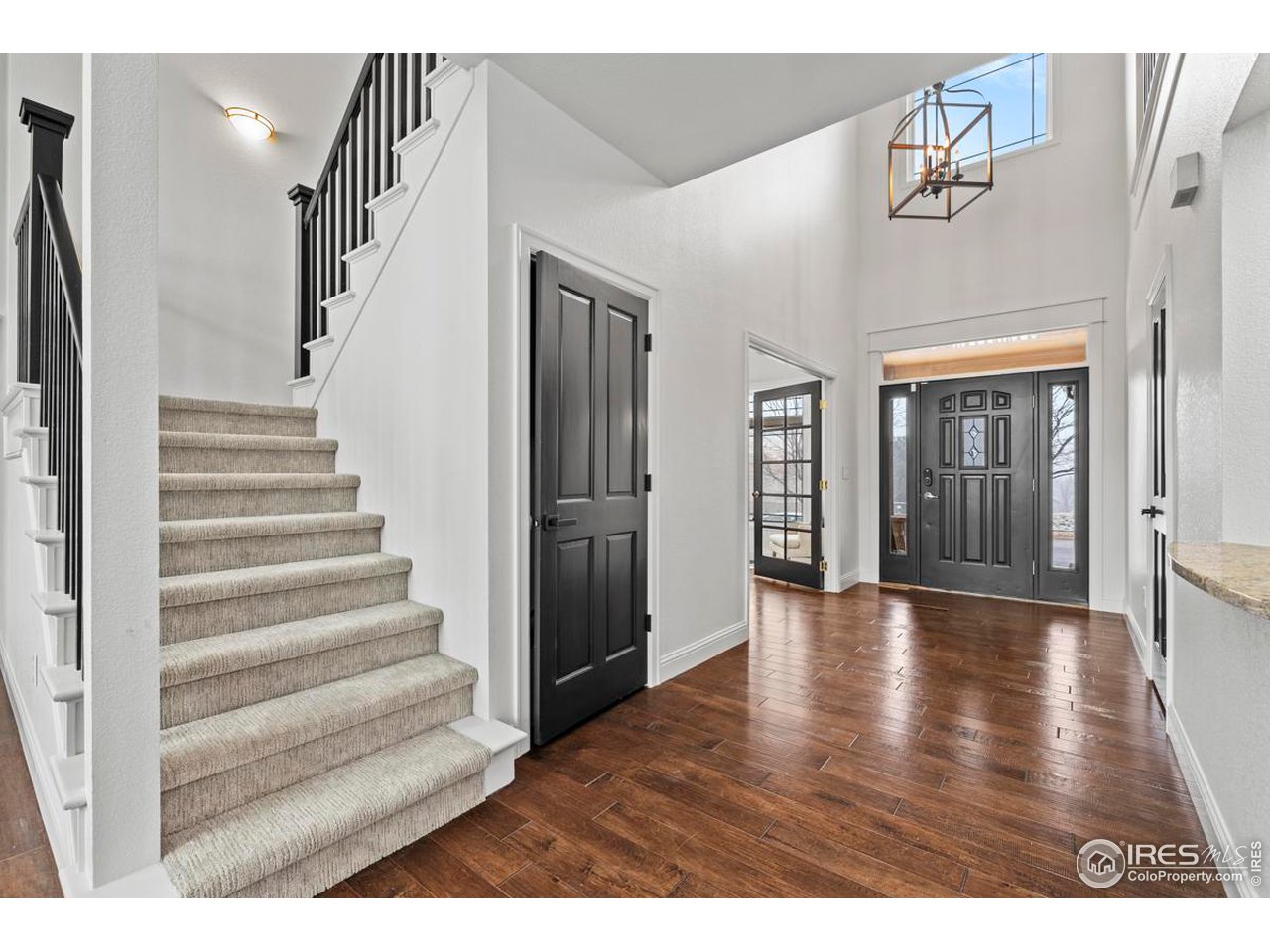 2097 Meander Road Windsor, CO 80550 - Photo 12 of 33 a view of an entryway with wooden floor