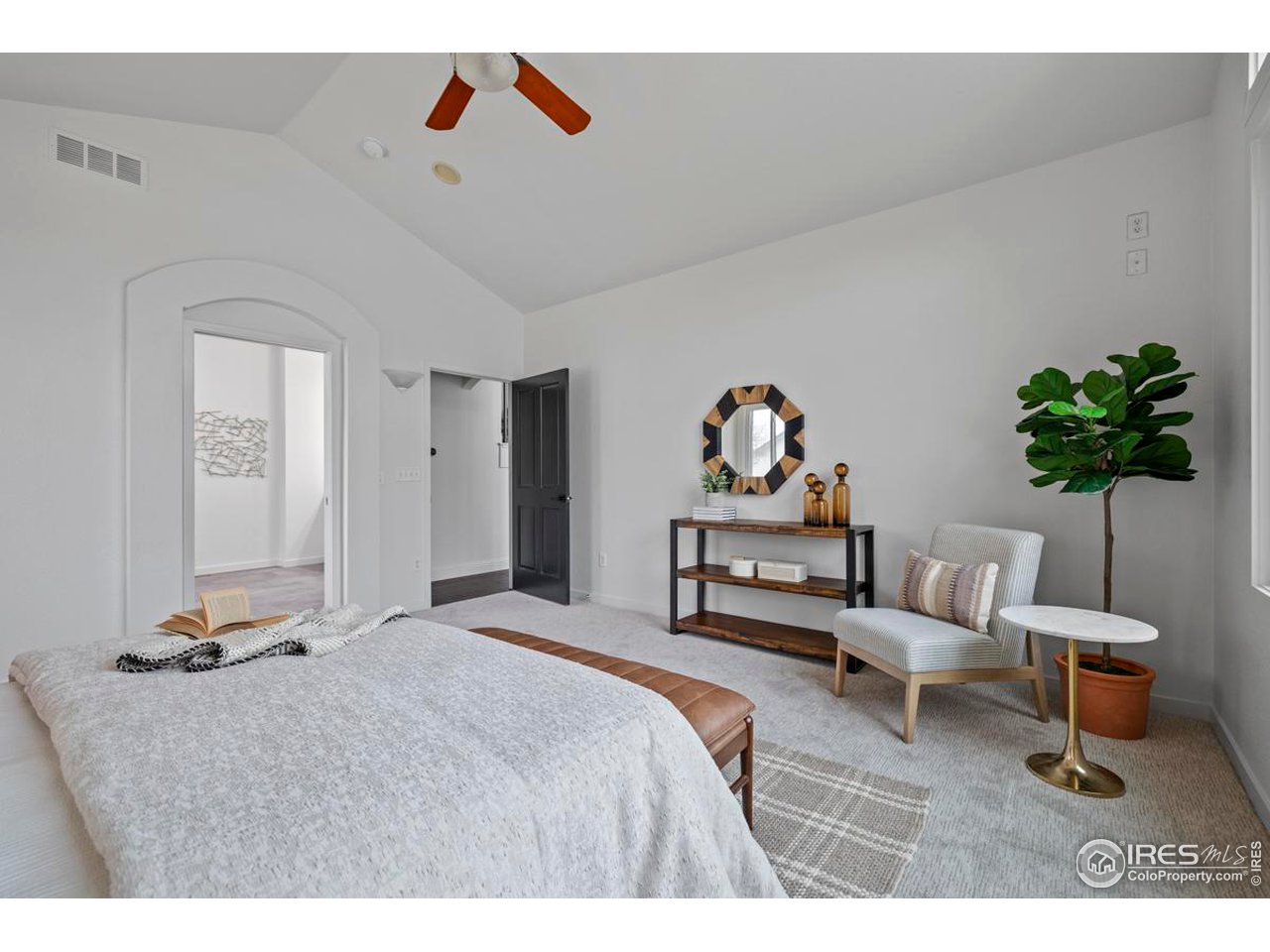 2097 Meander Road Windsor, CO 80550 - Photo 14 of 33 a bedroom with a bed a couch and a potted plant