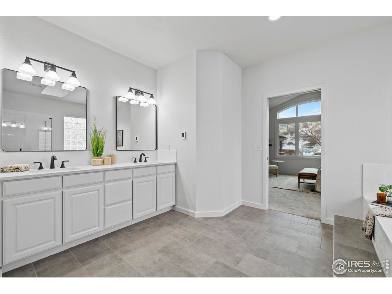 2097 Meander Road Windsor, CO 80550 - Photo 17 of 33 a spacious bathroom with a double vanity sink and a mirror