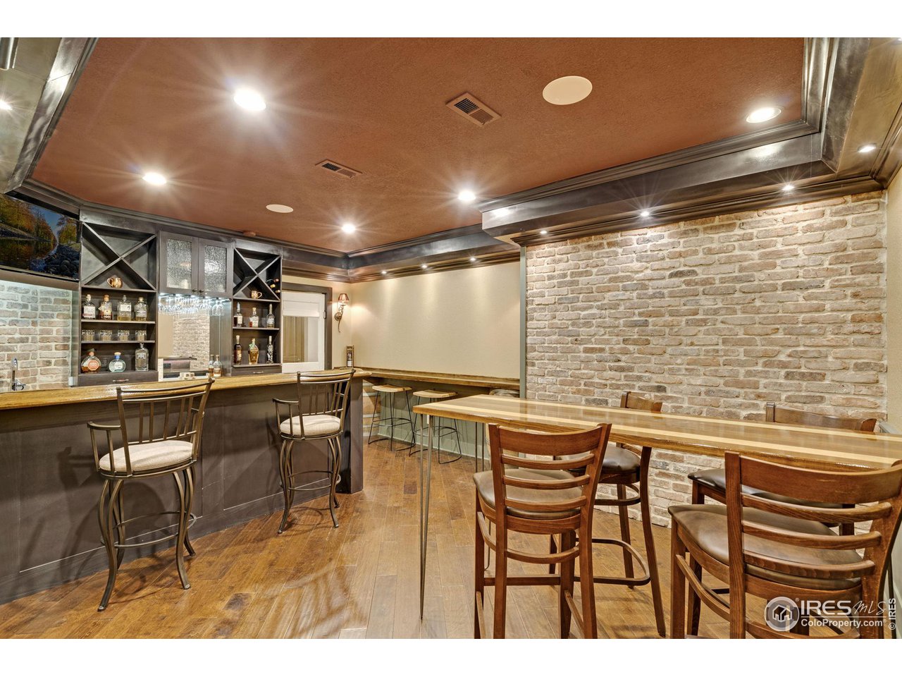 2097 Meander Road Windsor, CO 80550 - Photo 19 of 33 a kitchen with stainless steel appliances kitchen island granite countertop a dining table chairs and a refrigerator
